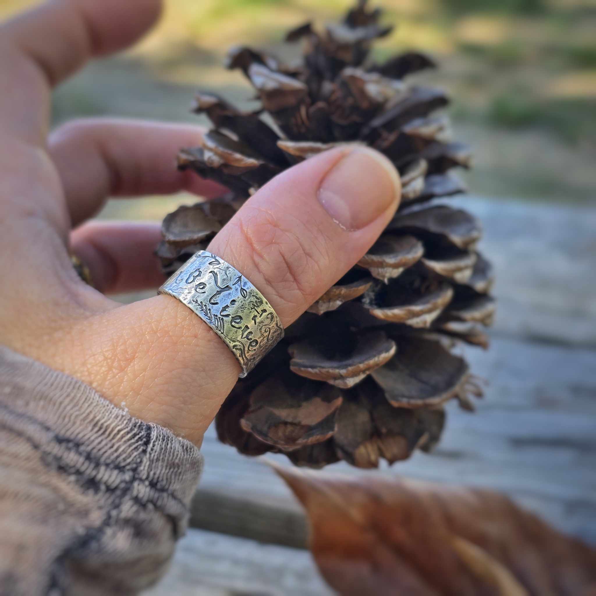 Sterling silver Believe ring on model’s hand