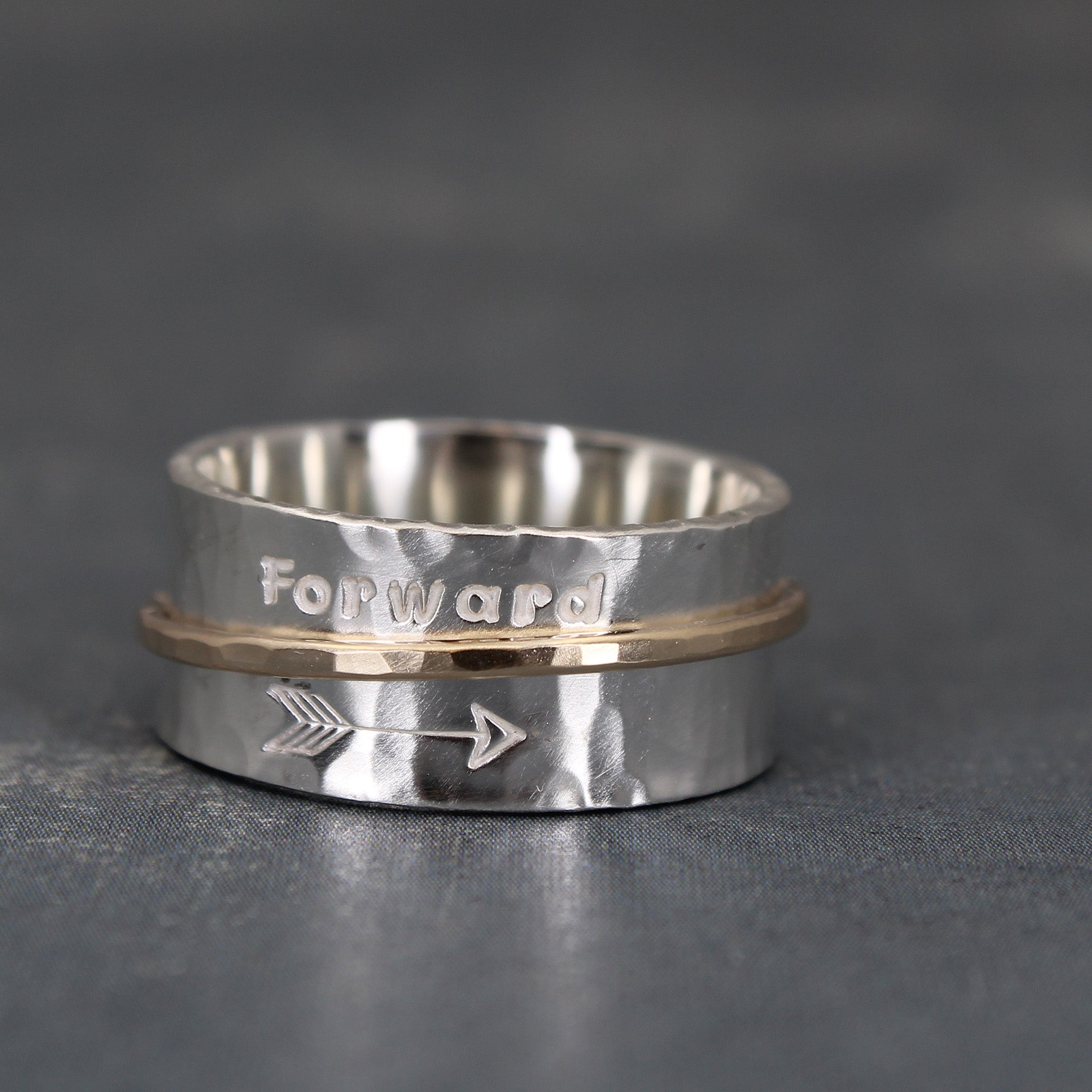 Handcrafted sterling silver spinner ring with solid 10k gold spinning band
