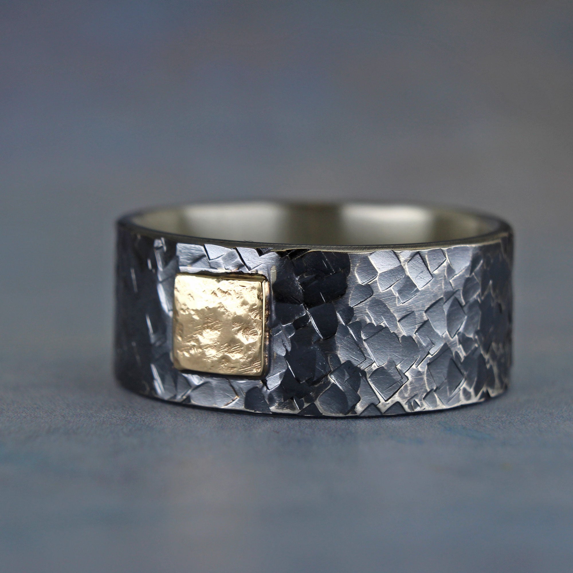 Wide rugged hammered sterling silver ring with distressed 14k gold square