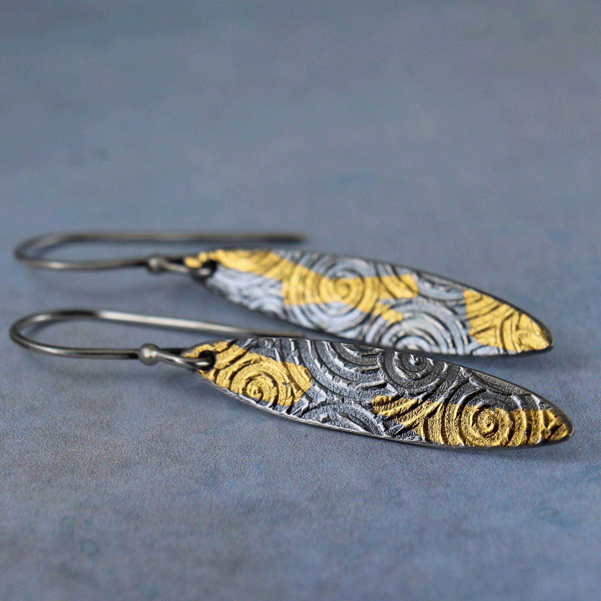 Sterling silver shield earrings with embossed spiral and 23k gold accents