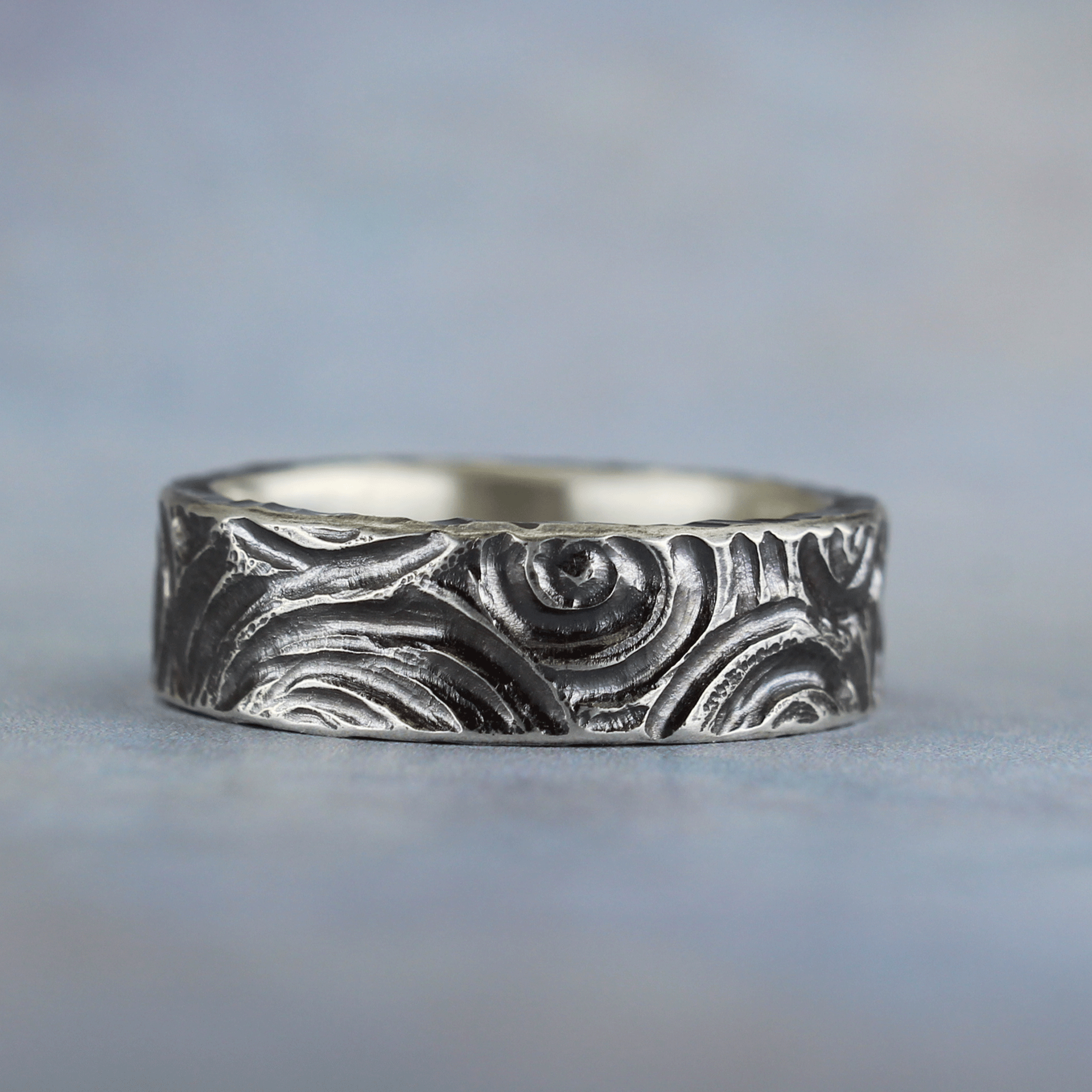 Sterling silver spiral ring with hand-carved design and dark patina – artisan made