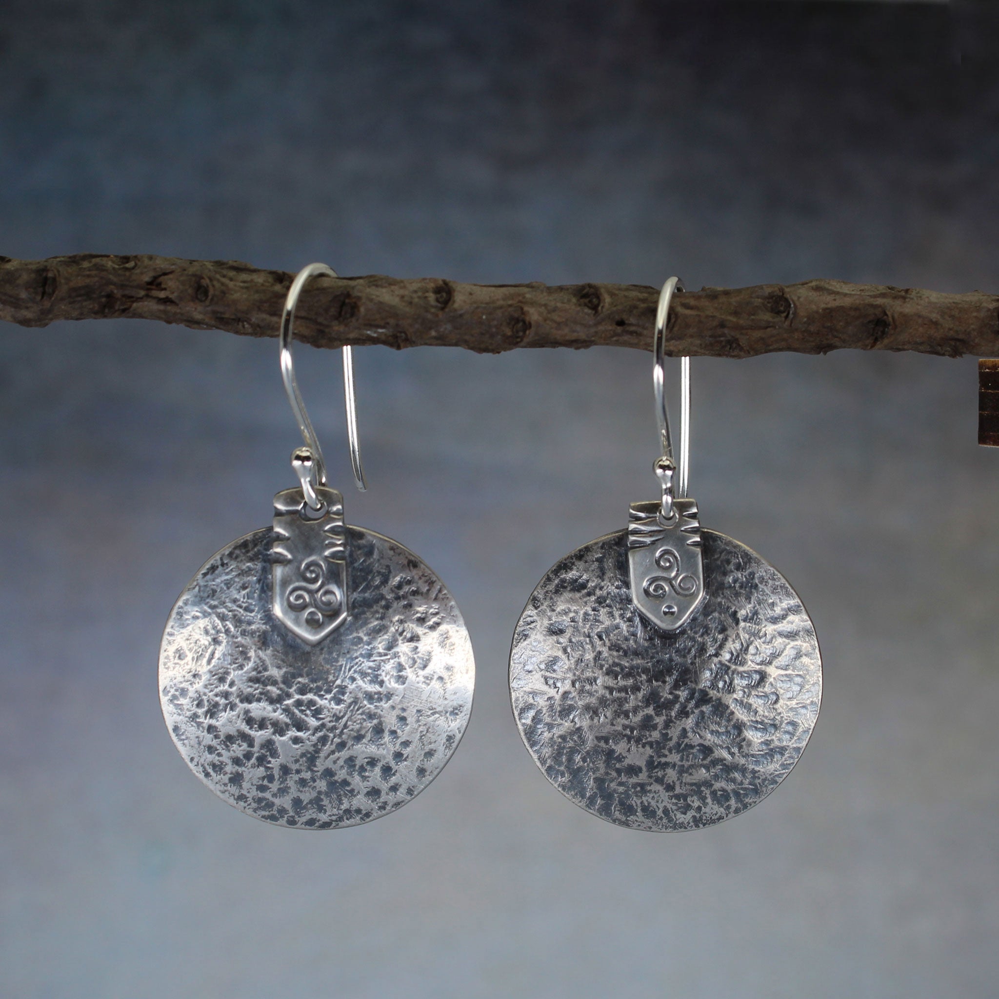Hand made earrings with rustic hammered discs and a triskele symbol, handmade.