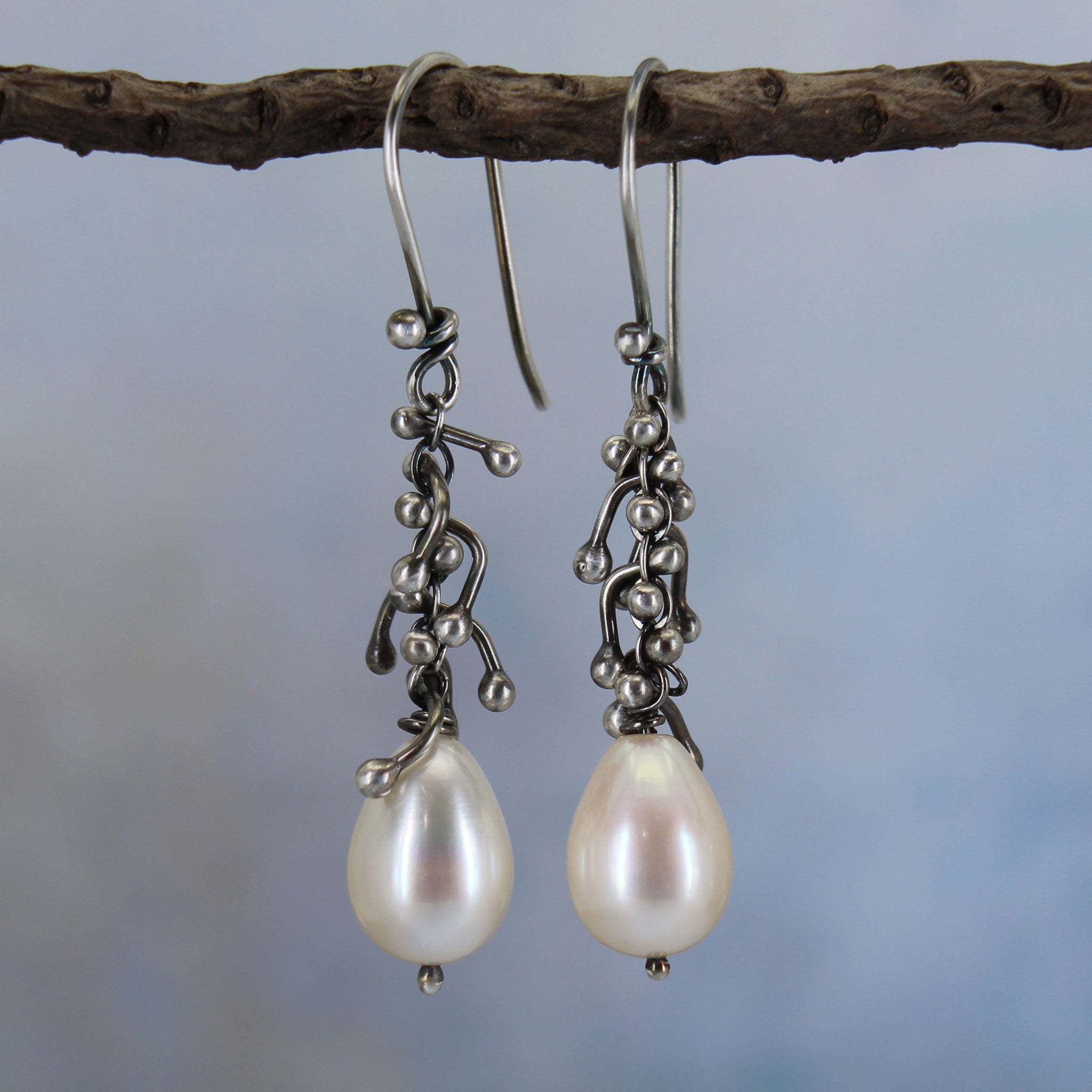 Handcrafted sterling silver pearl drop earrings with darkened organic texture and white freshwater pearls.
