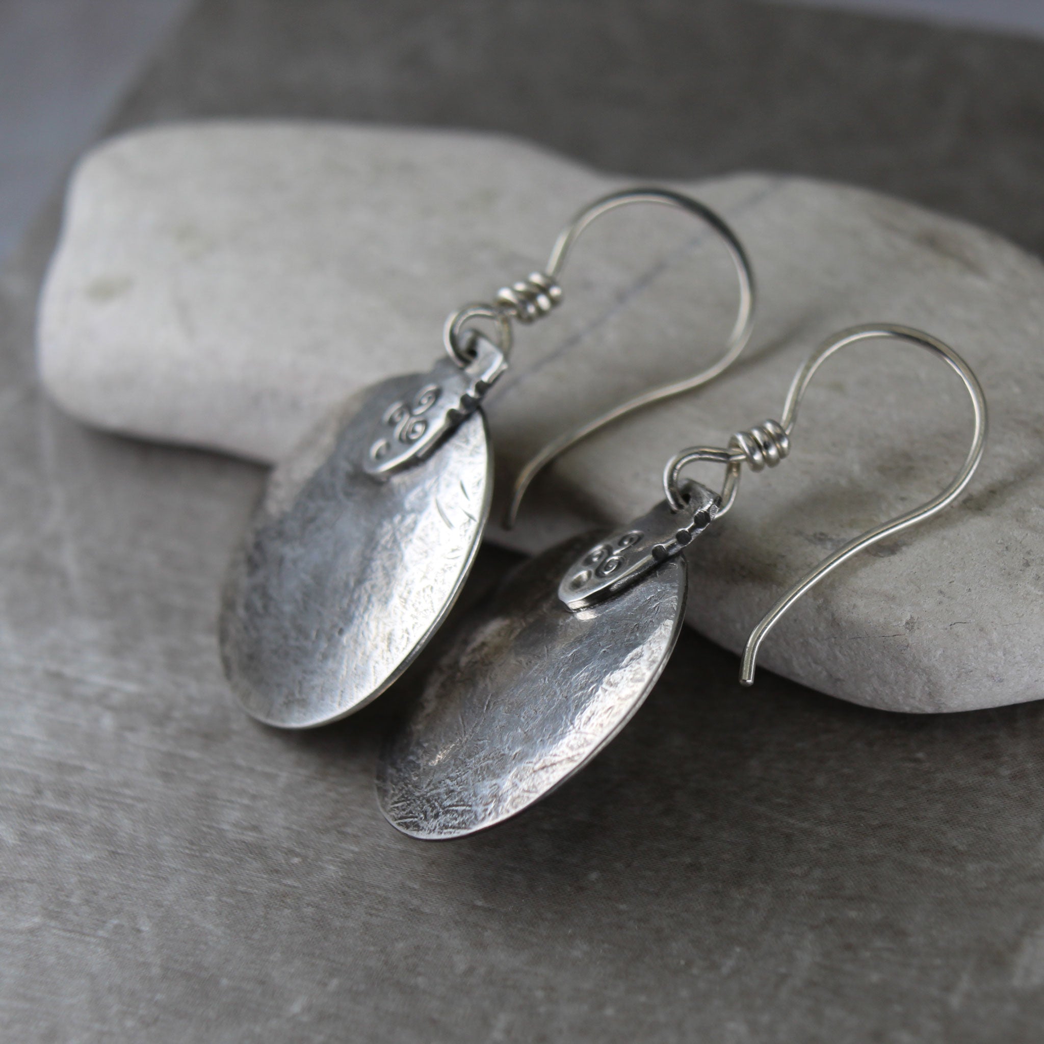 side view of the triskele disc earrings to show they are slightly domed