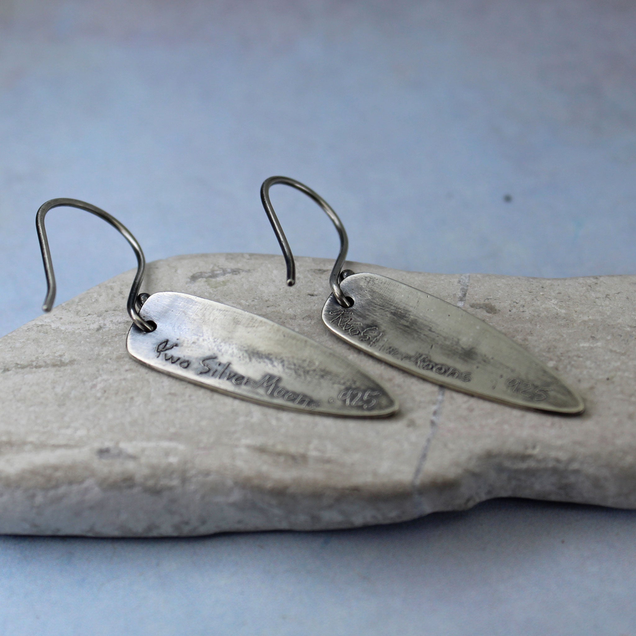 Sterling silver shield earrings on handcrafted French hooks shown from the back.