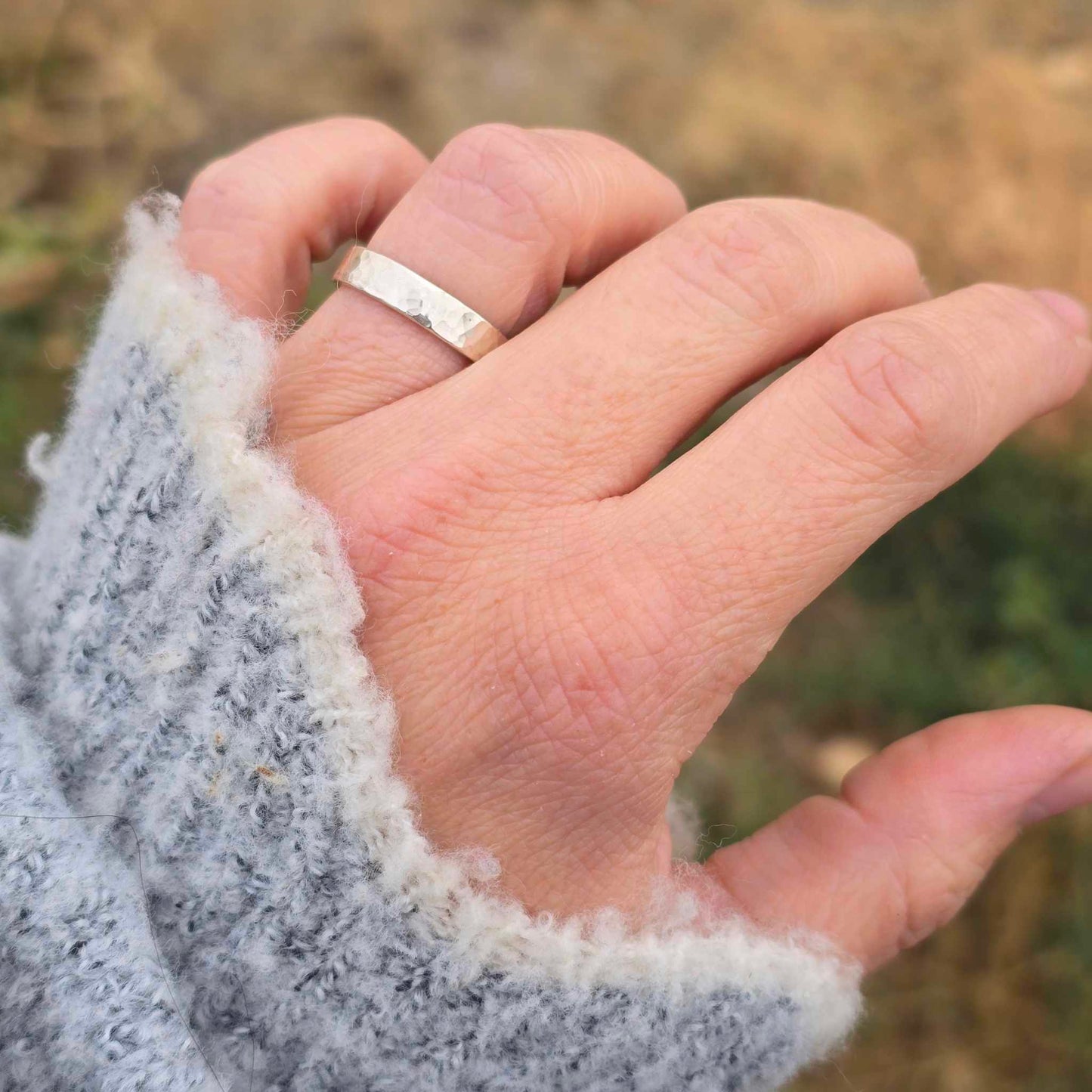 4mm wide hammered silver ring shown on hand