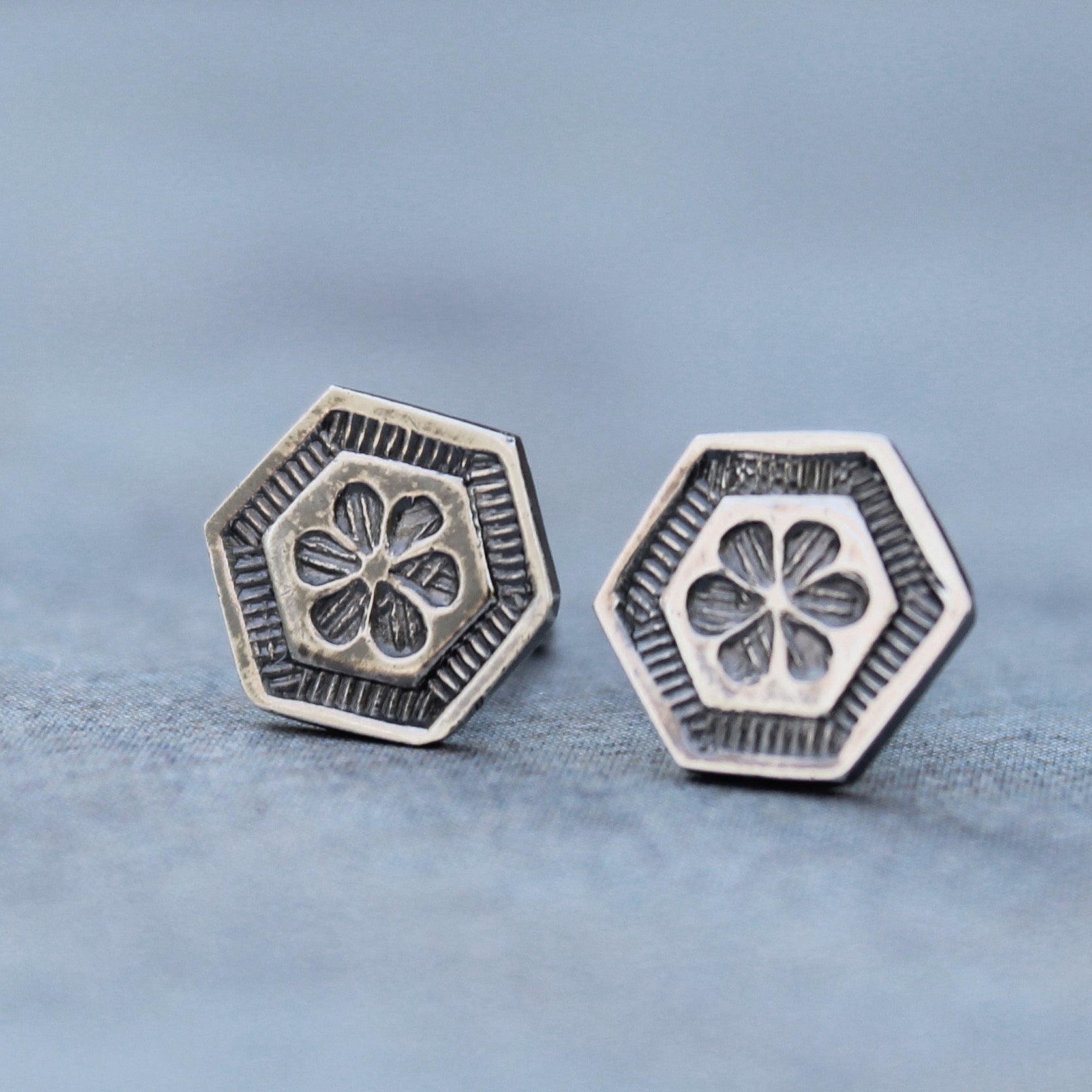 Sterling silver hexagon stud earrings with stamped floral design