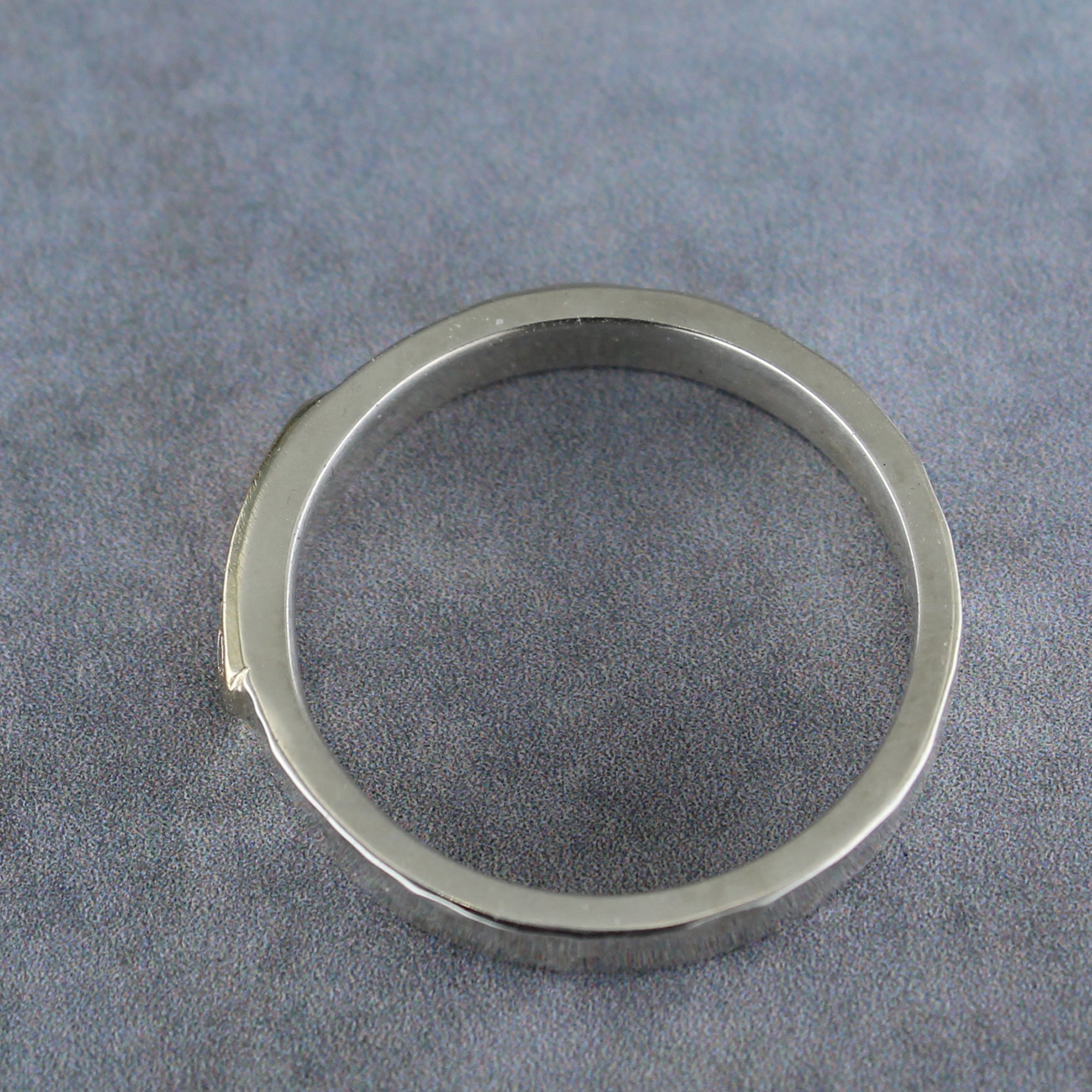 Side view of slim sterling silver band with soldered 10k gold tab
