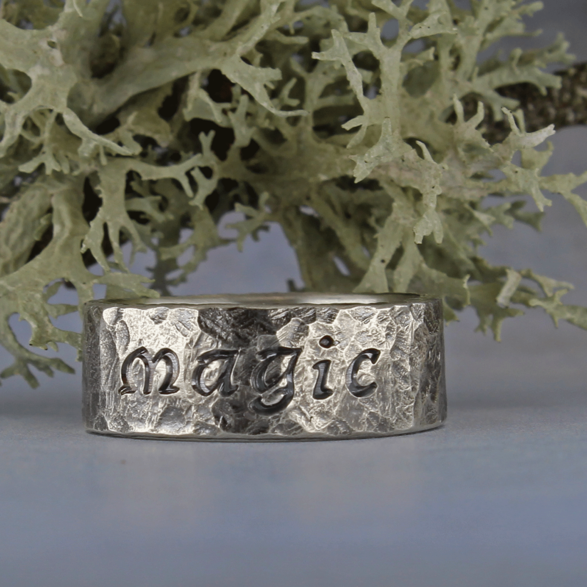 Rustic hammered silver ring with darkened lettering