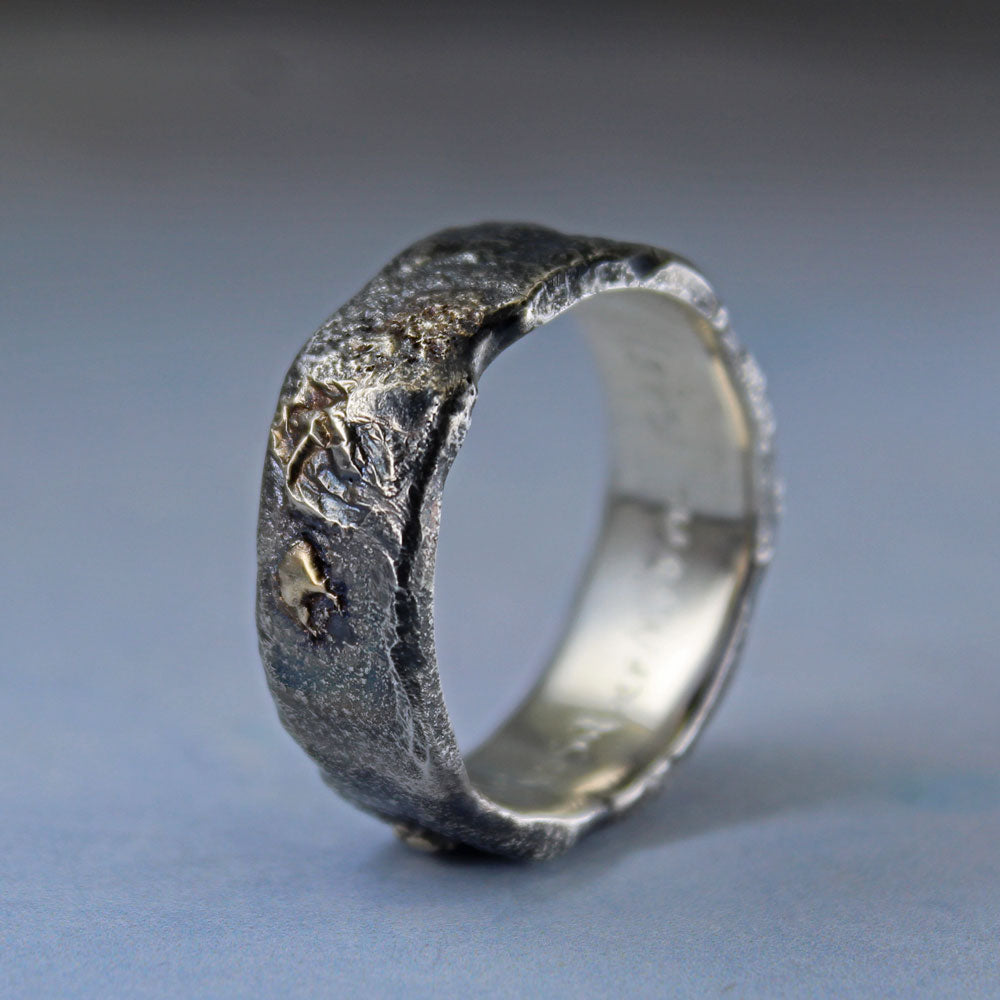 Molten sterling silver and 14k gold ring with aged finish shown from the side