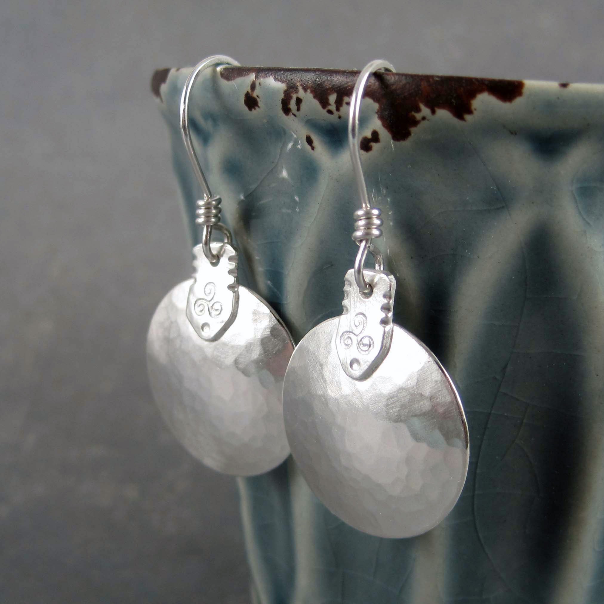 Sterling silver disc earrings, gently hammered with a triskele symbol