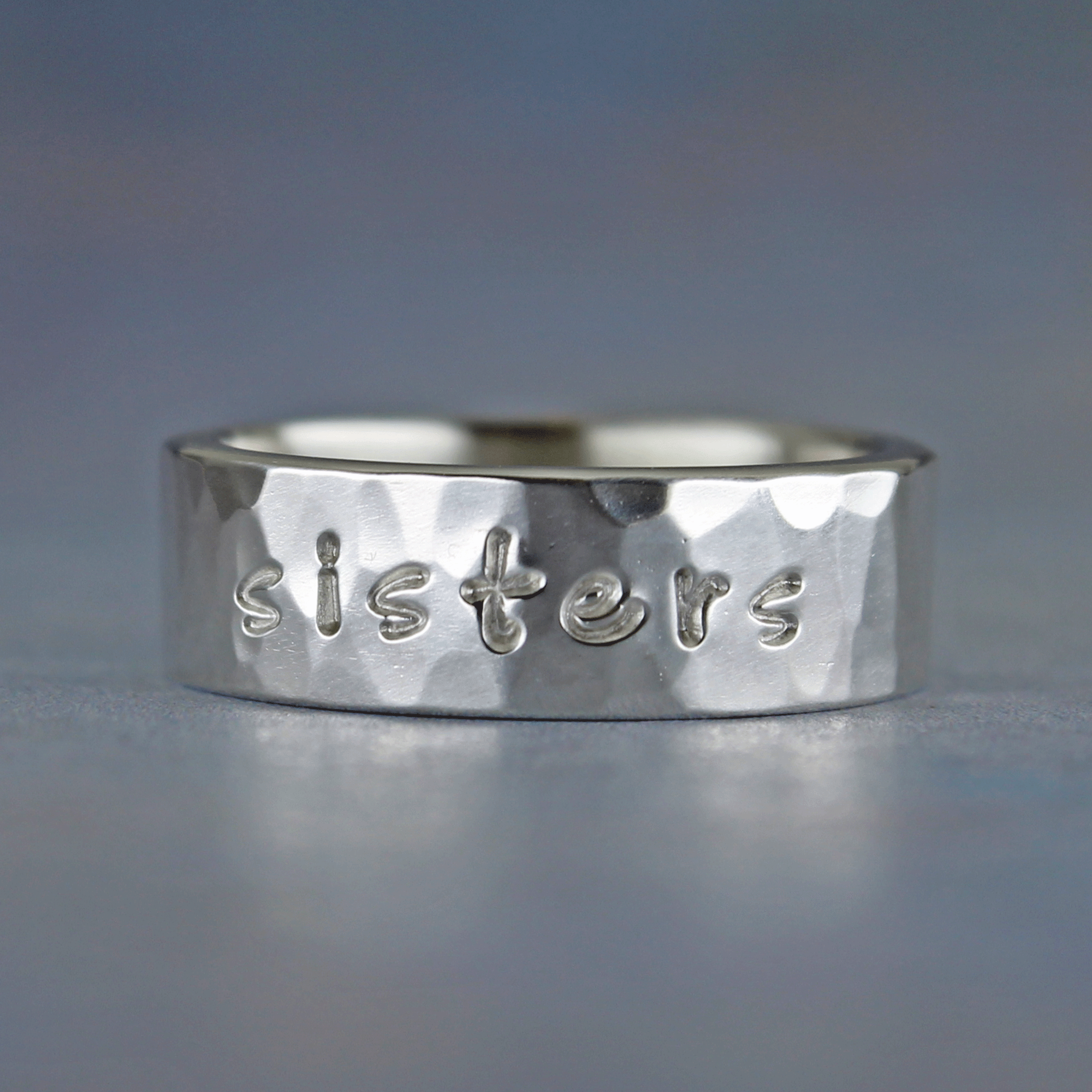 Sterling silver ring inscribed with the word sisters