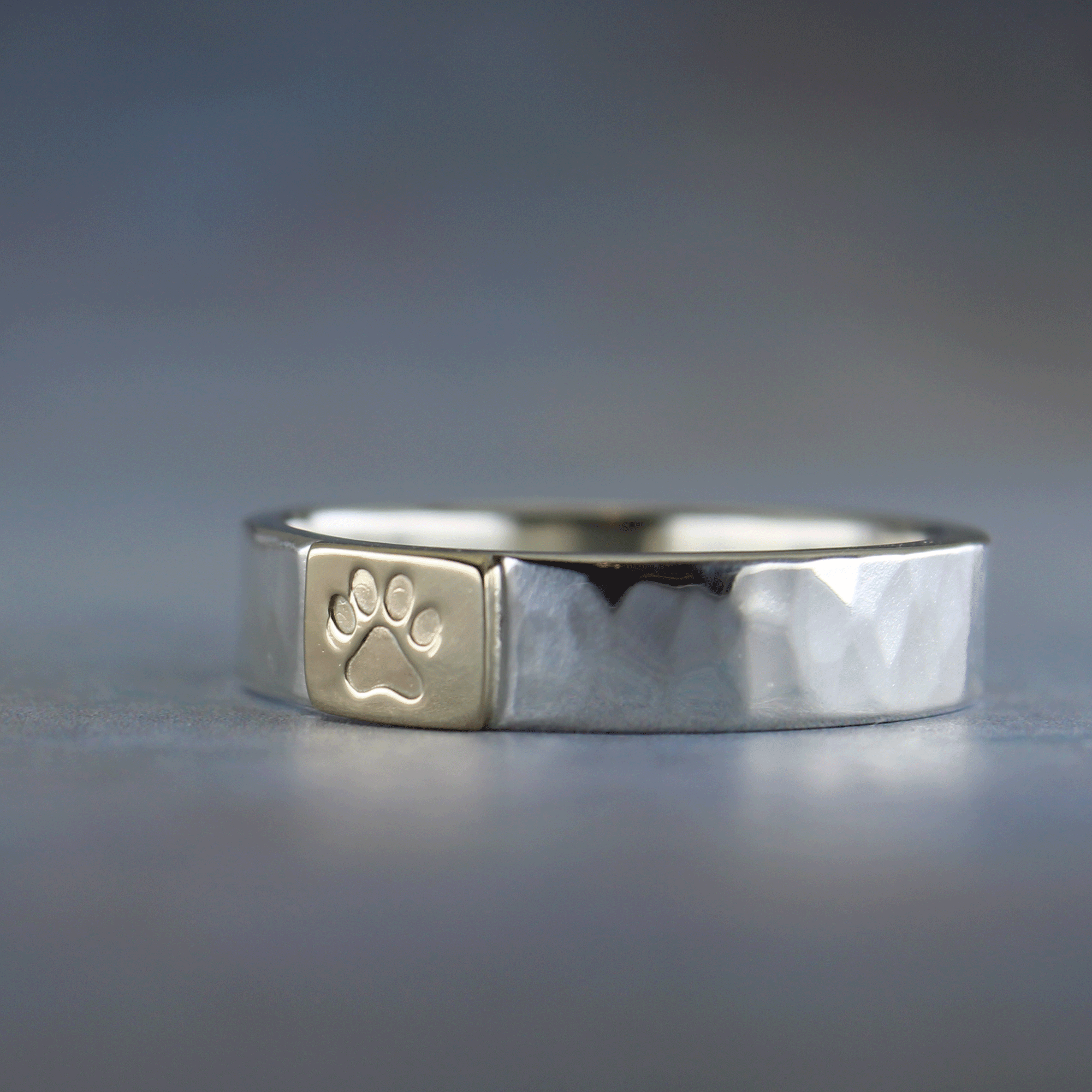Handmade paw symbol ring in sterling silver and 10k gold