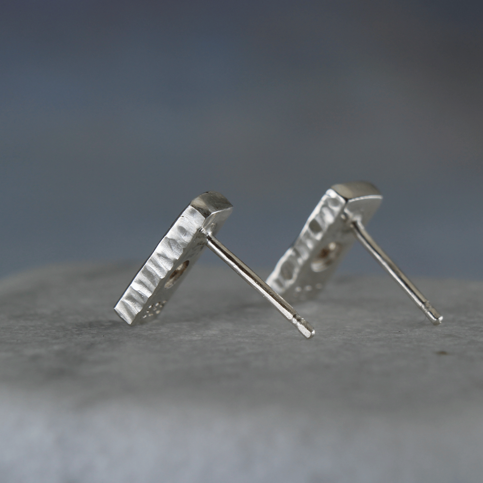 Gemstone silver bar studs shown from the side