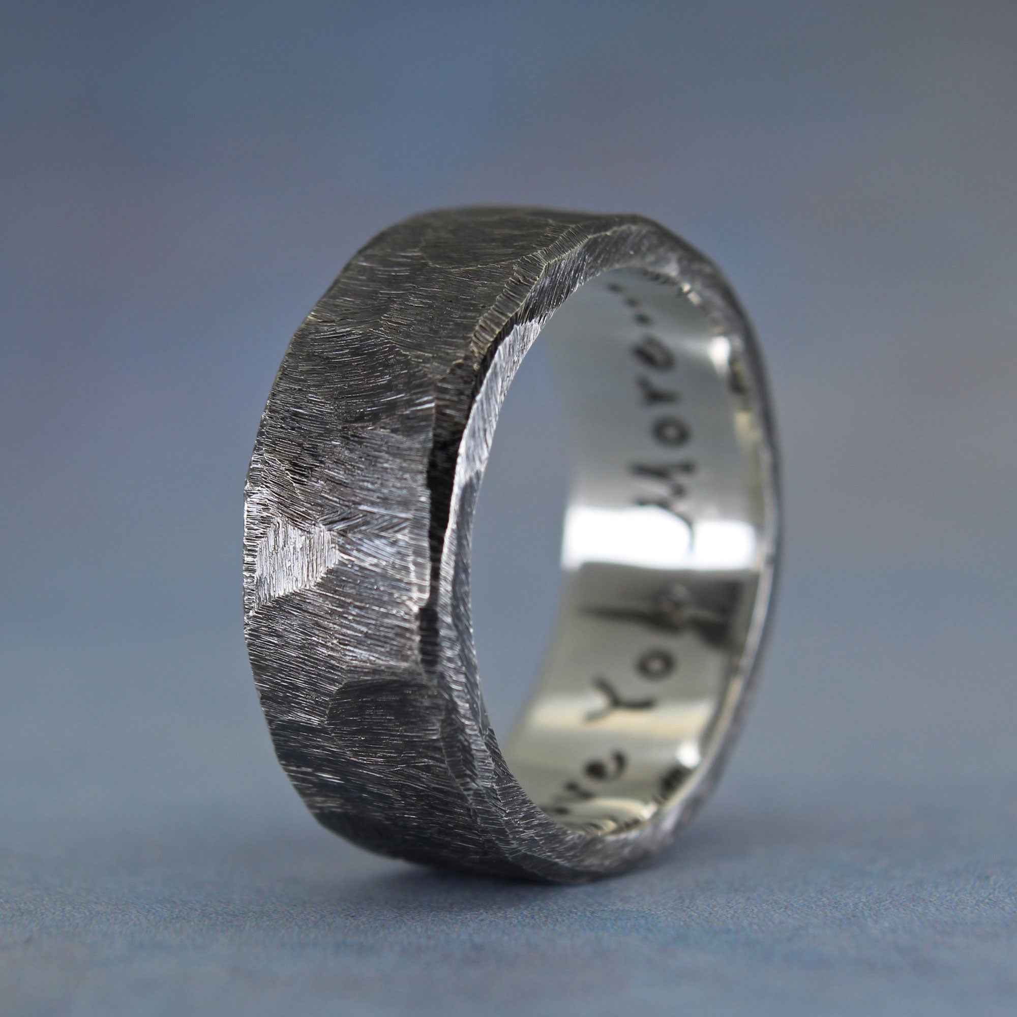 Side view of handcarved silver wedding band with custom inscription 