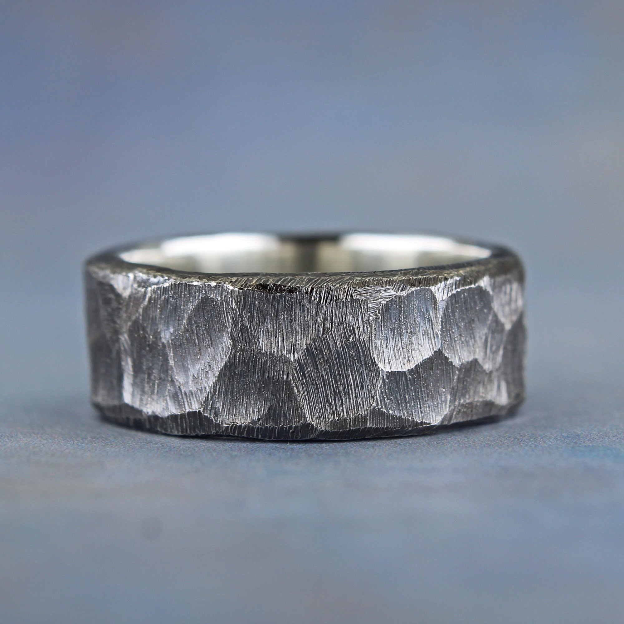 Hand-carved sterling silver wedding band with rustic texture and dark patina