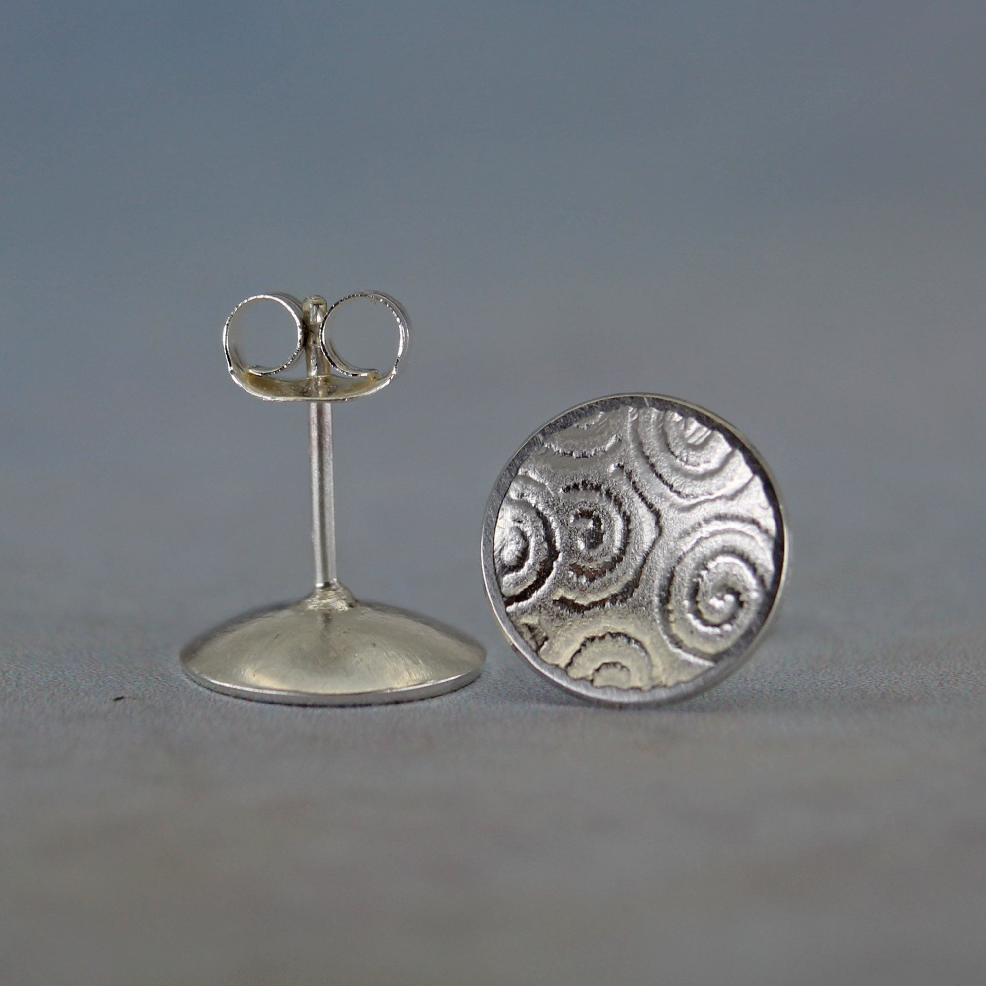 Back view showing sterling silver posts and butterfly backs on disc stud earrings
