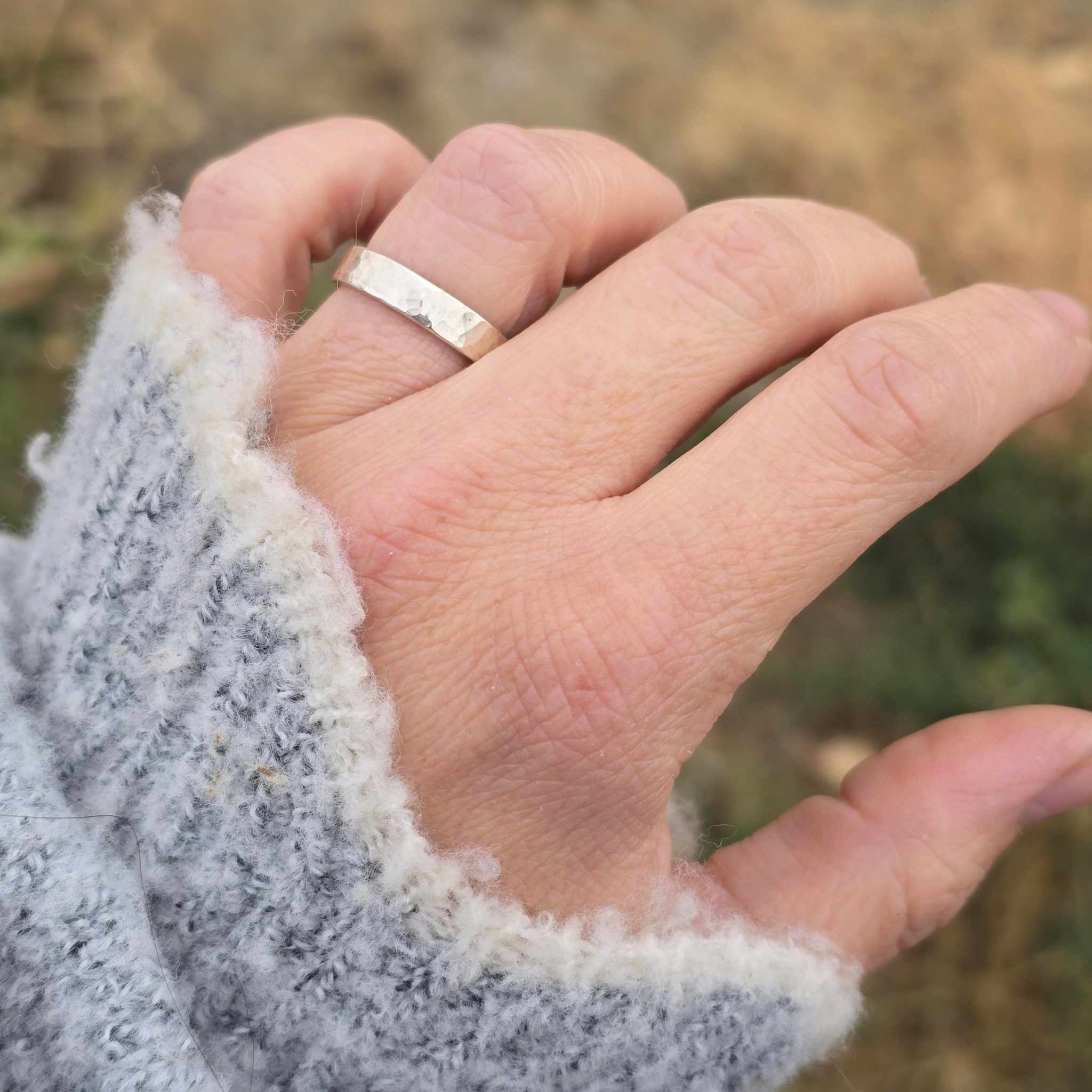 4mm wide hammered silver ring shown on hand