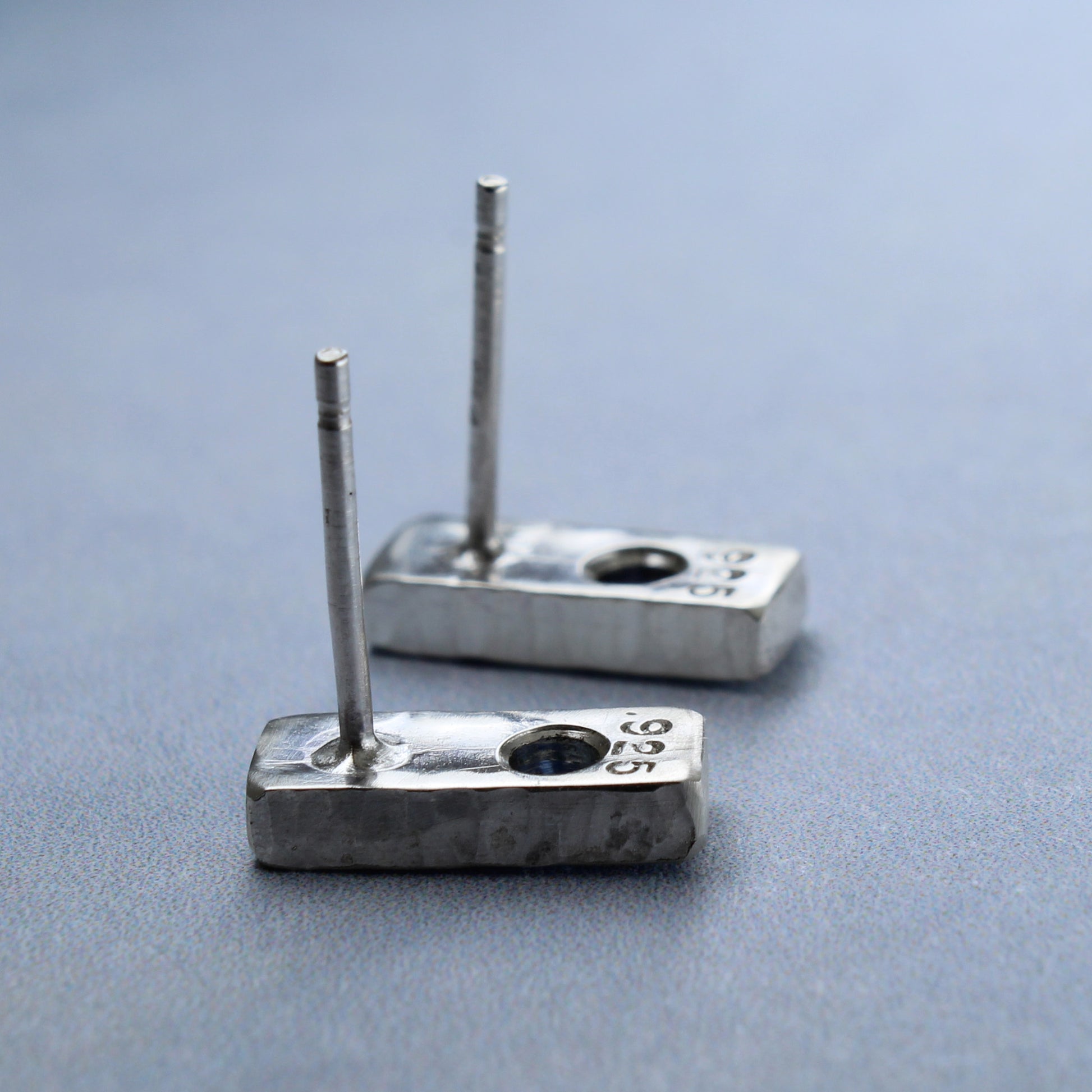 Sterling silver post earrings, hammered silver bars with blue sapphire gems, shown from back