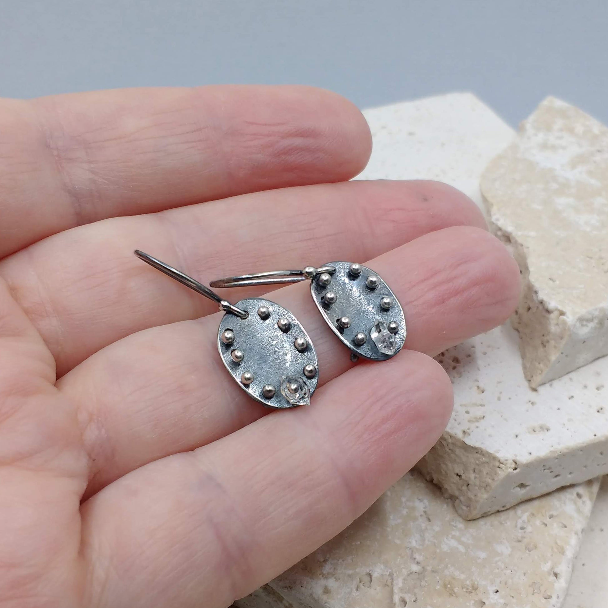 Metalwork moon pebble earrings