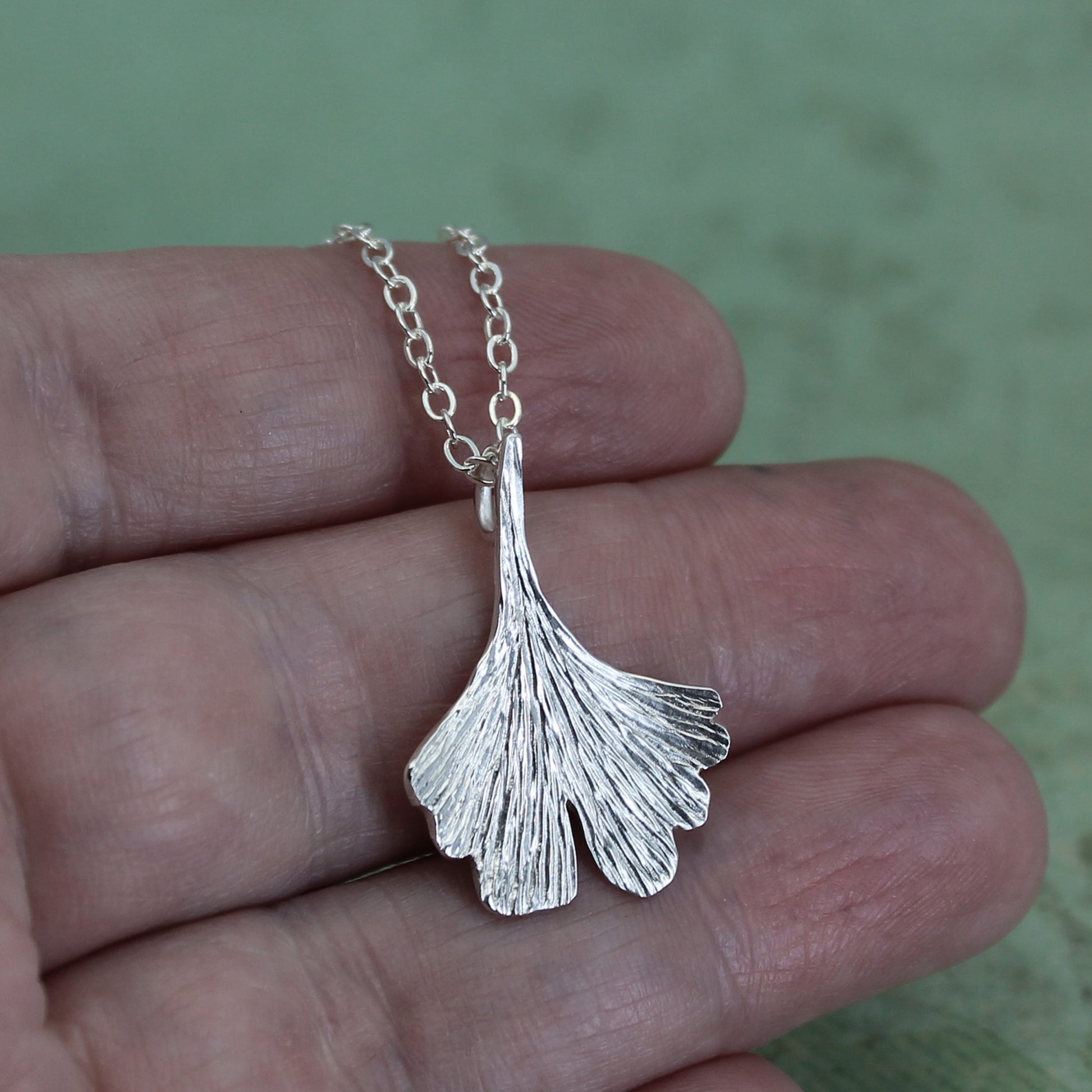 Ginkgo leaf necklace on hand
