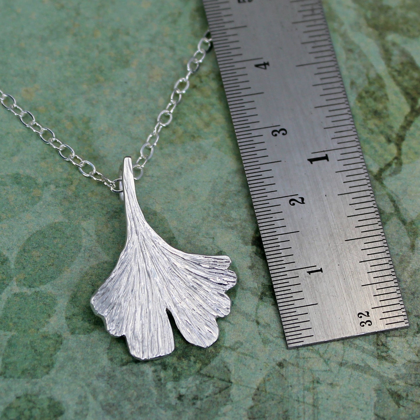 Silver ginkgo leaf with ruler