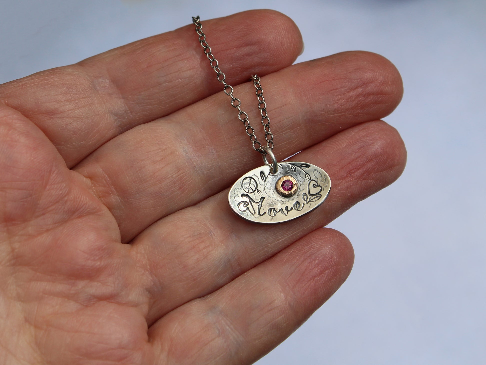 Love necklace shown on hand
