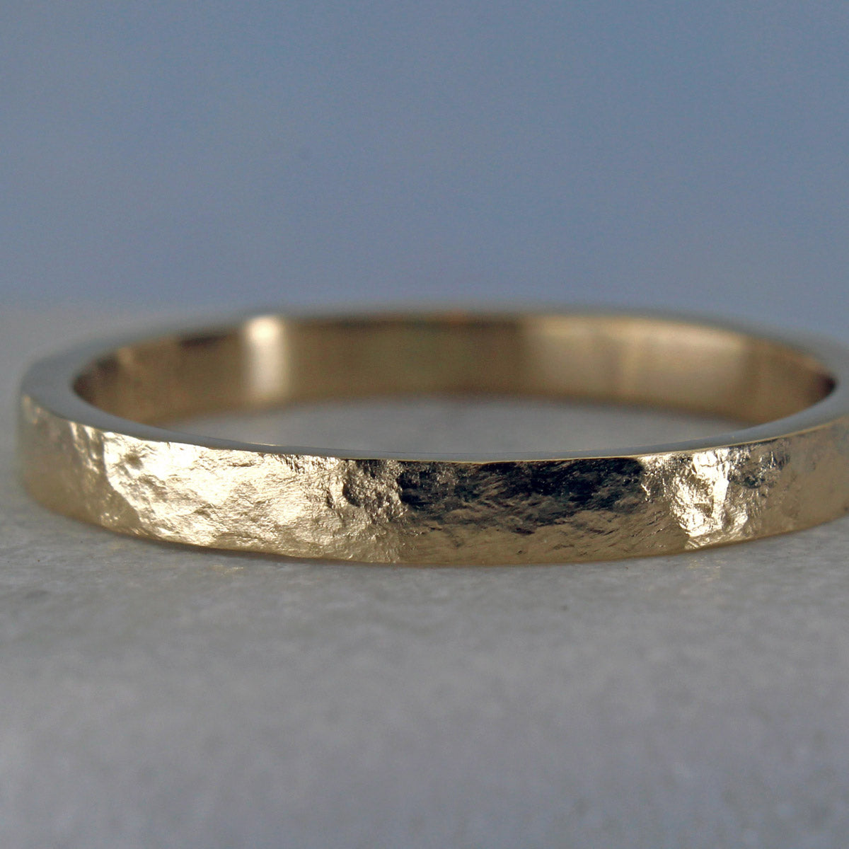 Closeup of the distressed hammered finish on the 14k gold ring. 
