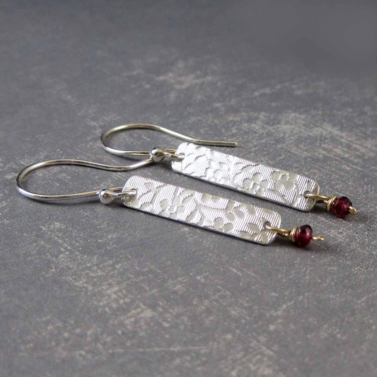 embossed silver earrings with garnet beads