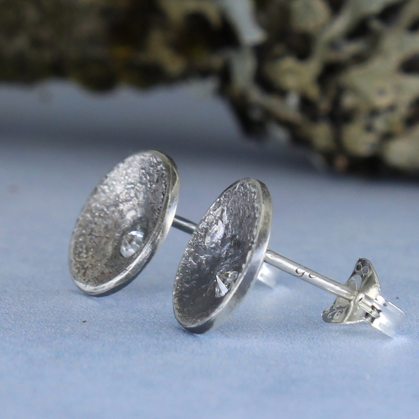 Silver earrings shown from the side